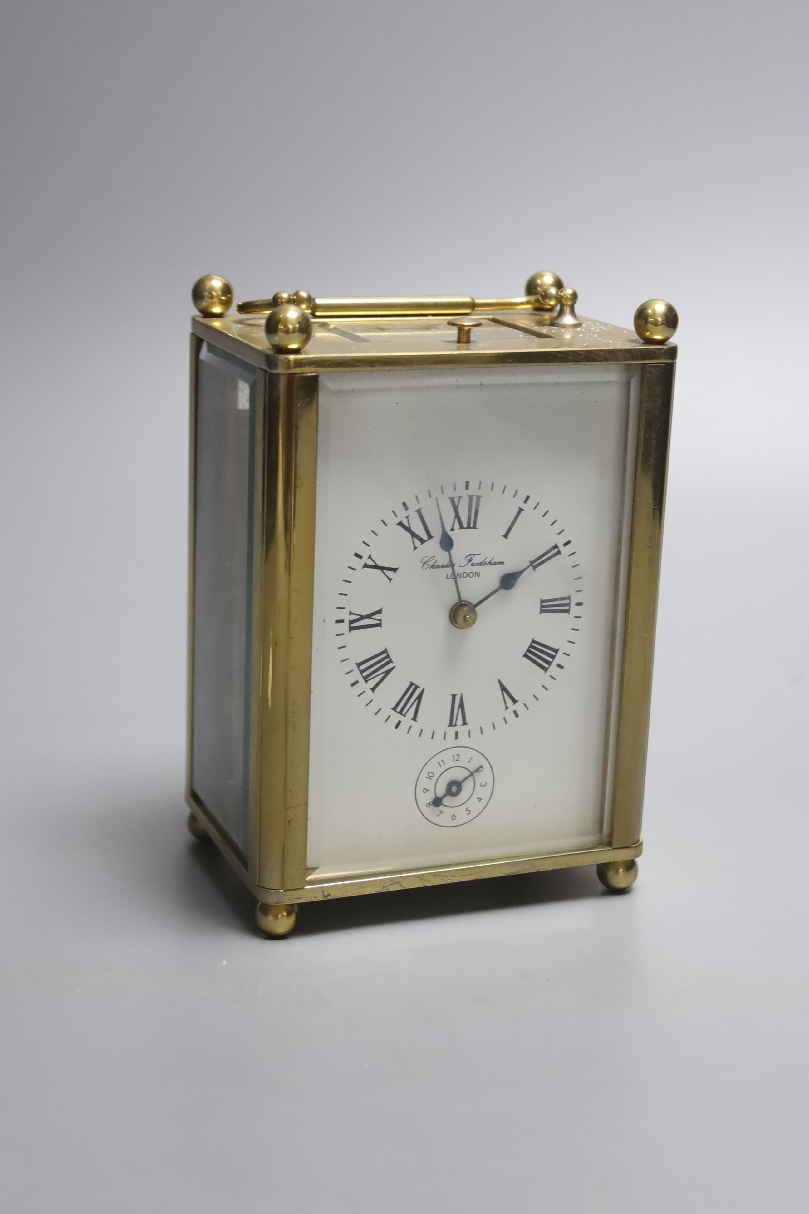 A Charles Frodsham brass cased repeating carriage clock, height 14cm with handle down